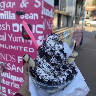 Oreo Crumb ice cream w cut doughnut in the bottom of the cup w hazelnut wafers.