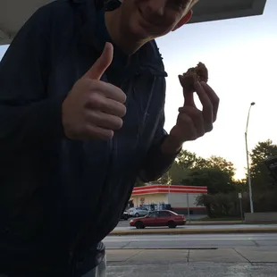 My friend Sam eating a blueberry cake donut from Donut Pantry at a gas station! Yum!