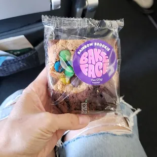 a person holding a bag of doughnuts