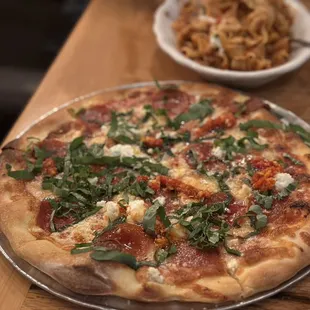 a pizza with spinach and cheese