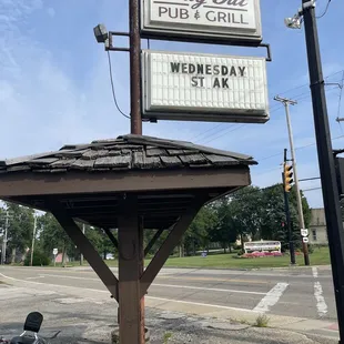 a motorcycle parked in front of the sign
