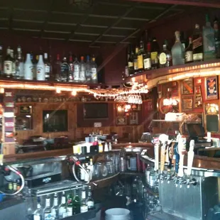 a bar with a lot of bottles on the shelves