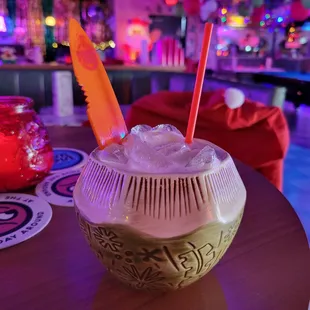 a drink in a coconut bowl