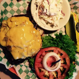 a hamburger, coleslaw, and a pickle