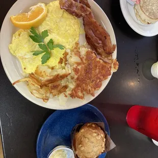 Scrambled eggs, bacon, hash browns and a banana nut muffin