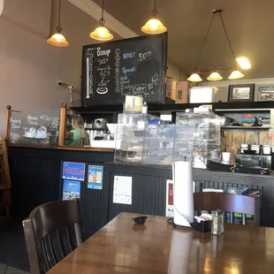 a coffee shop with a menu on the wall