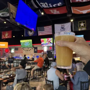 a person holding a glass of beer