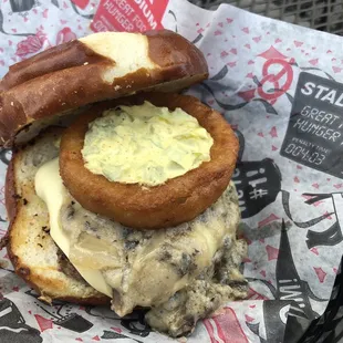 Poutine Burger (single patty topped with mushroom gravy, pickle relish, onion ring &amp; melted Swiss cheese served on a pretzel bun)