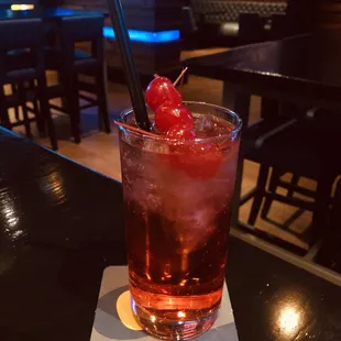 a drink with a cherry garnish