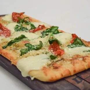 a pizza on a cutting board