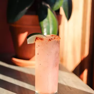 a pink drink with a lime slice