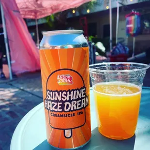 a can and a glass of orange juice