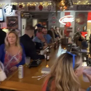 a group of people sitting at a bar