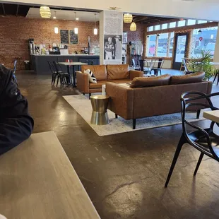 Interior shots of sofas, tables and coffee bar