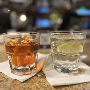 two glasses of alcohol on a table
