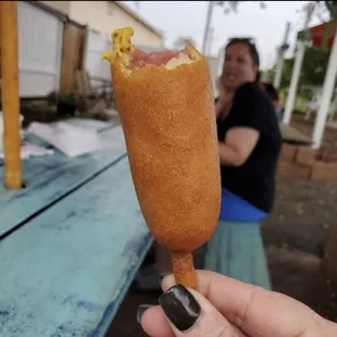 a person eating a hot dog