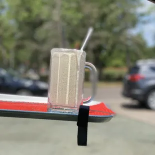 a glass of milkshake with a straw in it