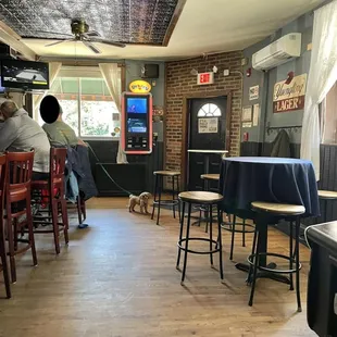 a man and his dog sitting at a bar