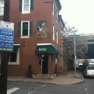 a brick building with a green awning