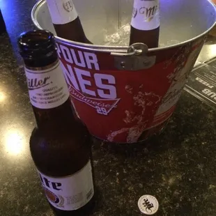 a bucket full of beer bottles