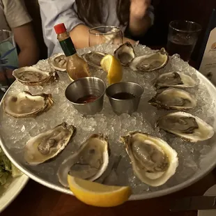 a platter of oysters on ice