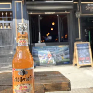 a bottle of beer on a wooden table