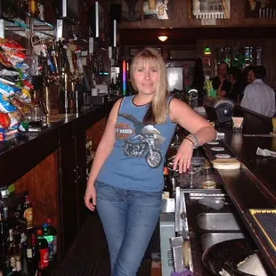 a woman standing at a bar