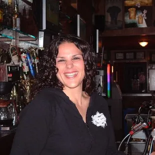 a smiling woman in a bar