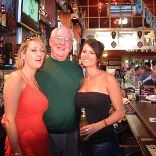 a man and two women at a bar