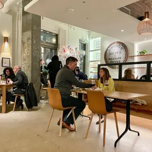 people sitting at tables in a restaurant