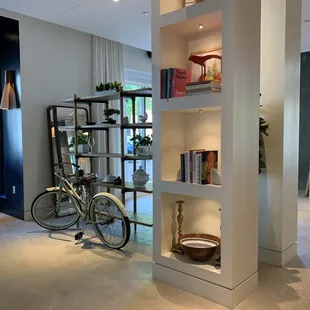 a bicycle leaning against a bookcase