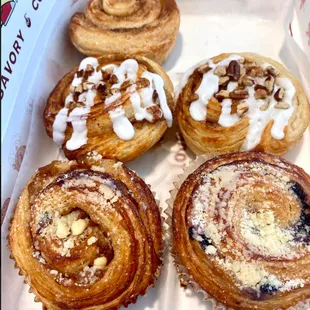 Back: Original Cinnamon Roll; Middle: Pecanilla Crunch; Front: Peach Cobbler and Blueberry Cobbler