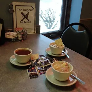 three cups of soup on a table