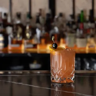 a cocktail in a glass on a bar