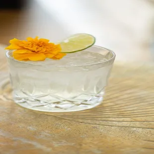 a glass of water with a flower on top
