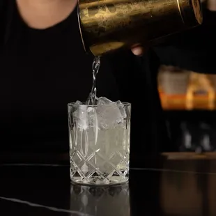a bartender pouring a drink