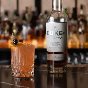 a glass of rum and a bottle of rum