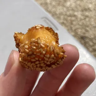 a hand holding a donut