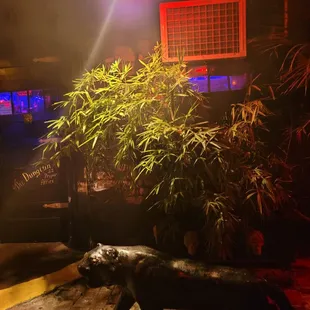 a statue of a cat and a plant