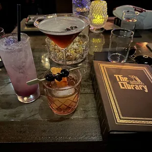 a table with cocktails and books