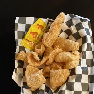 Crispy chicharrones and Valentina go great with an ice cold beer