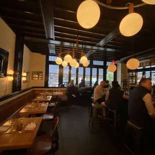 people sitting at tables in a restaurant