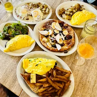 a variety of breakfast foods on a wooden table