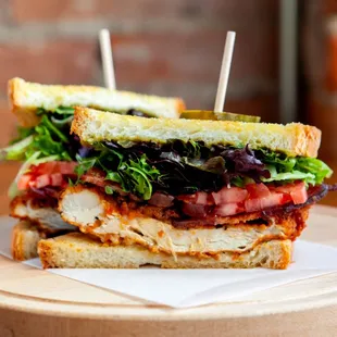 a chicken sandwich with lettuce and tomato