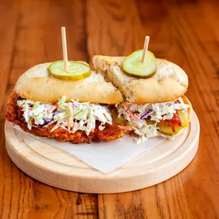 two sandwiches with pickles and cole slaw