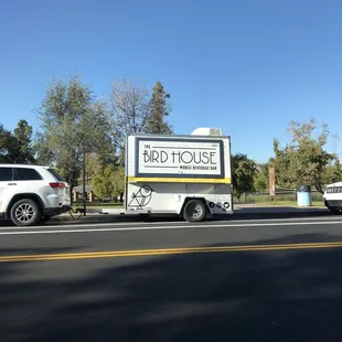 a bird house on the side of the road