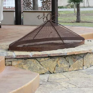 a fire pit in the middle of a patio