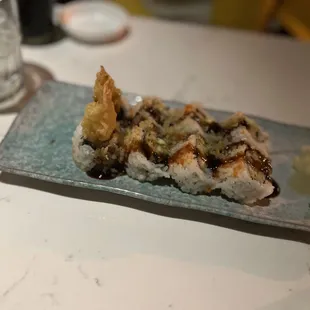 a plate of sushi and a glass of water