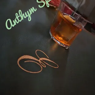 a glass of tea and a knife on a table