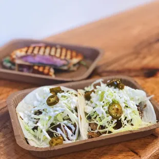 Taco Tuesday - 2 pulled pork tacos with caramelized onion, green slaw, quest fresco, sweet and spicy jalapeños and lime cream on flour torti